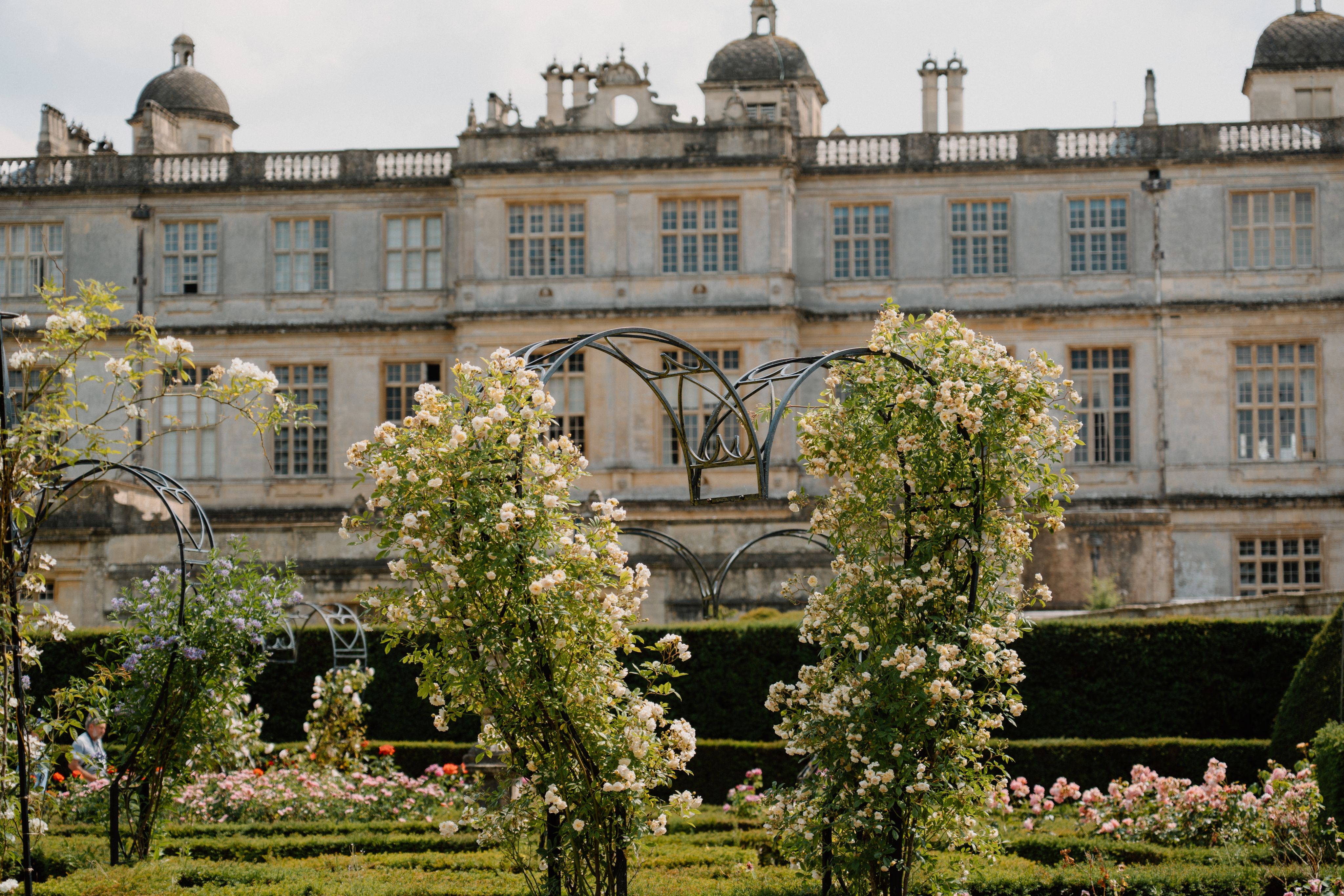 The rose garden with heart shaped trellises. Longleat House is in the background.